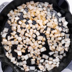 onions sautéing in a skillet