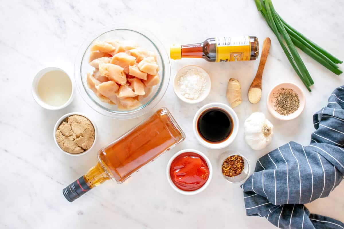 overhead view of ingredients for bourbon chicken in individual bowls.