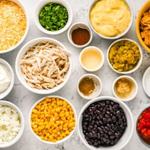 overhead view of ingredients for frito casserole in individual bowls.