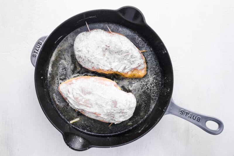 chicken breasts cooking in a skillet