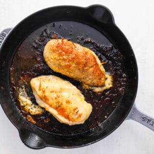 stuffed chicken cooking in a skillet