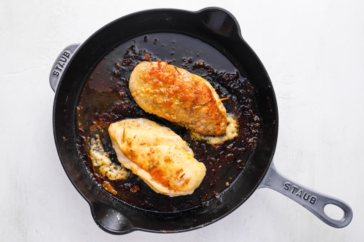 stuffed chicken cooking in a skillet