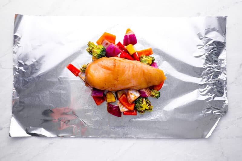 chicken breast and vegetables on a sheet of foil