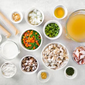 overhead view of ingredients for chicken bacon pot pie in individual bowls.