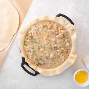 chicken bacon pot pie filling poured over a bottom pie crust in a pie pan.