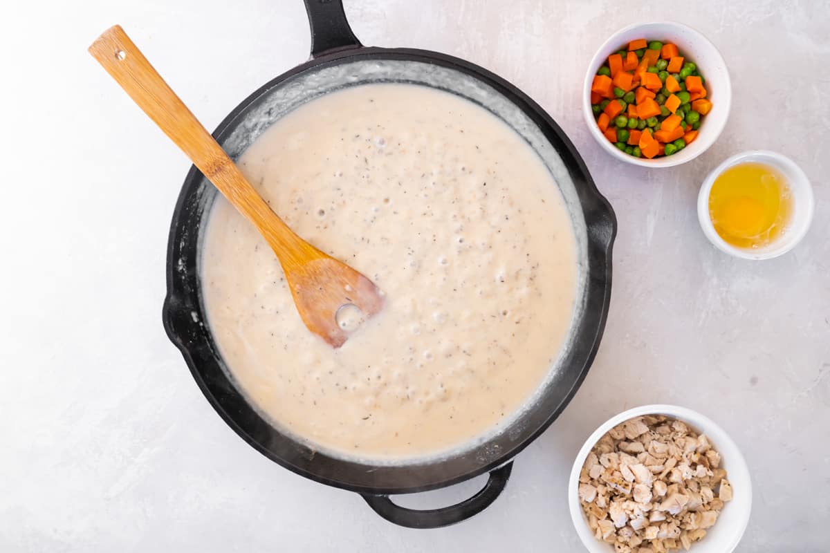 Creamy mixture cooking in a skillet.