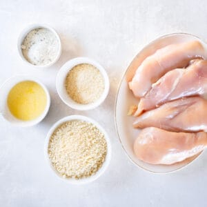 overhead view of ingredients for parmesan ranch chicken in individual bowls.