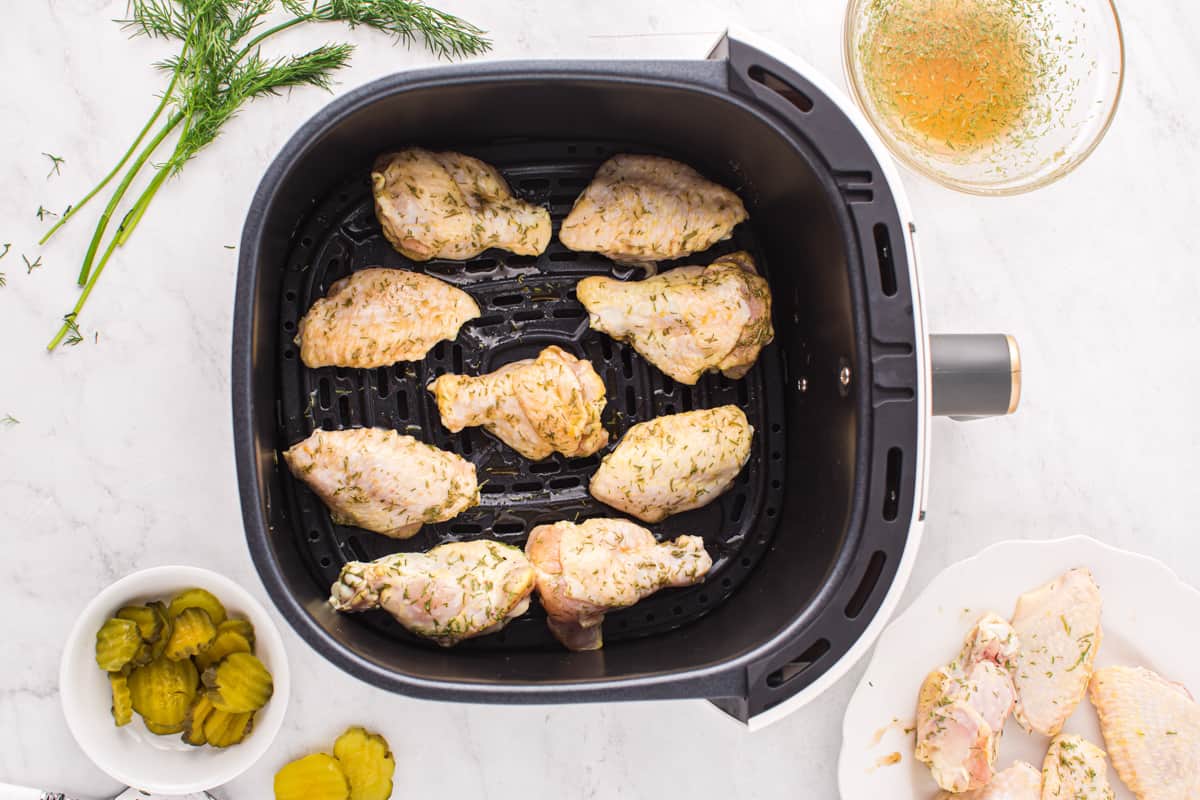 chicken wings cooking in an air fryer