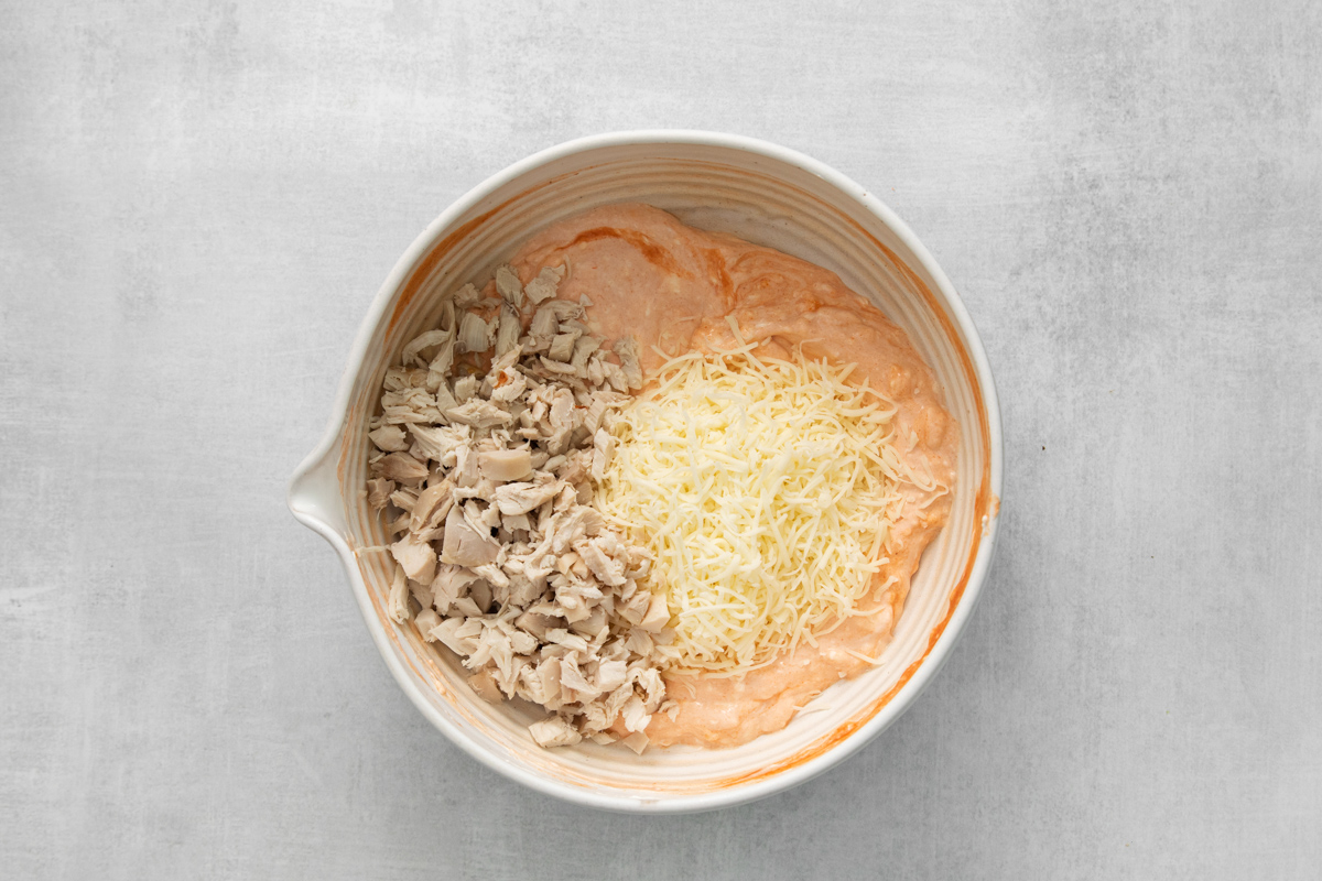 Shredded chicken and shredded cheese mixed into a creamy buffalo dip.