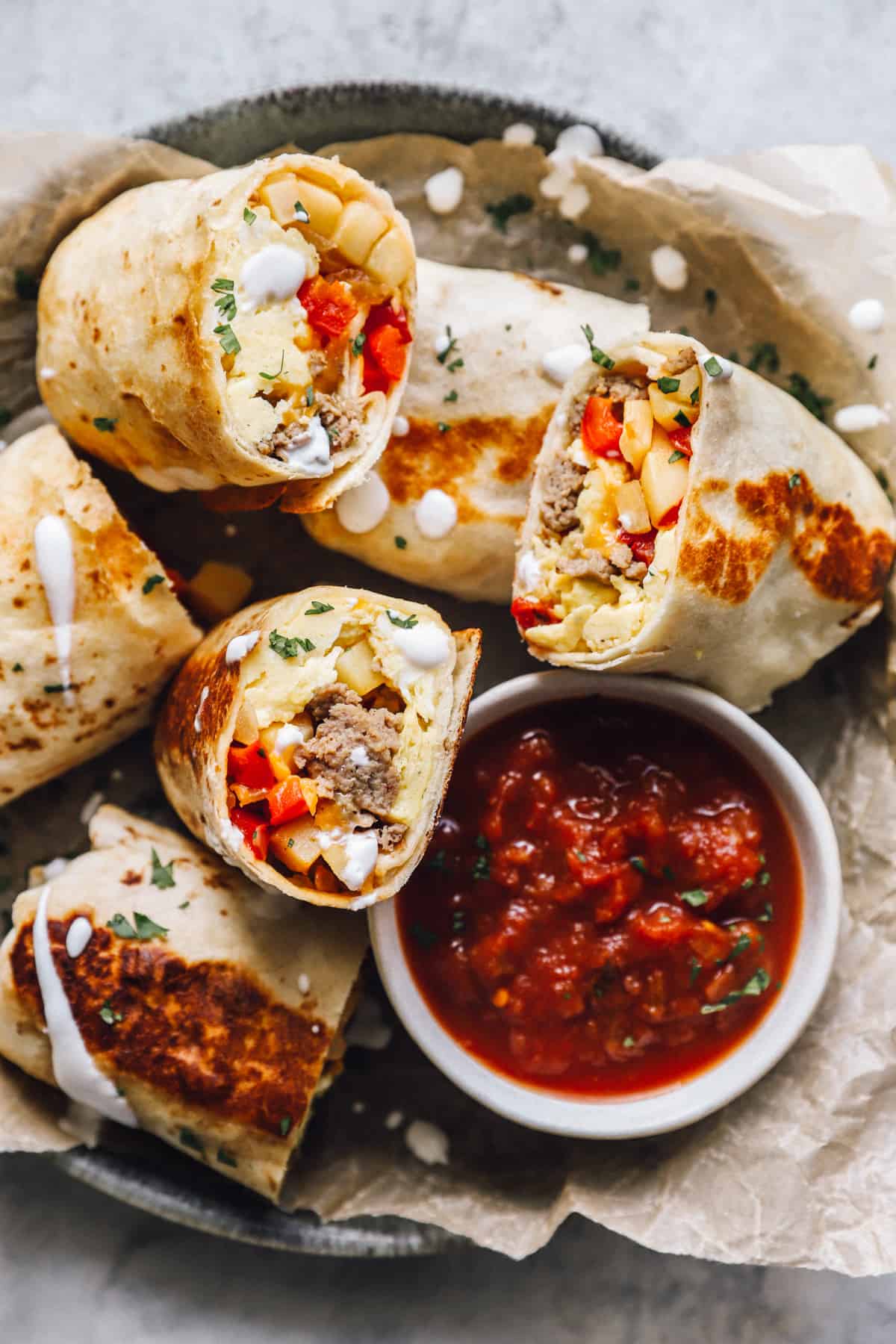 a basket of breakfast burritos cut in half