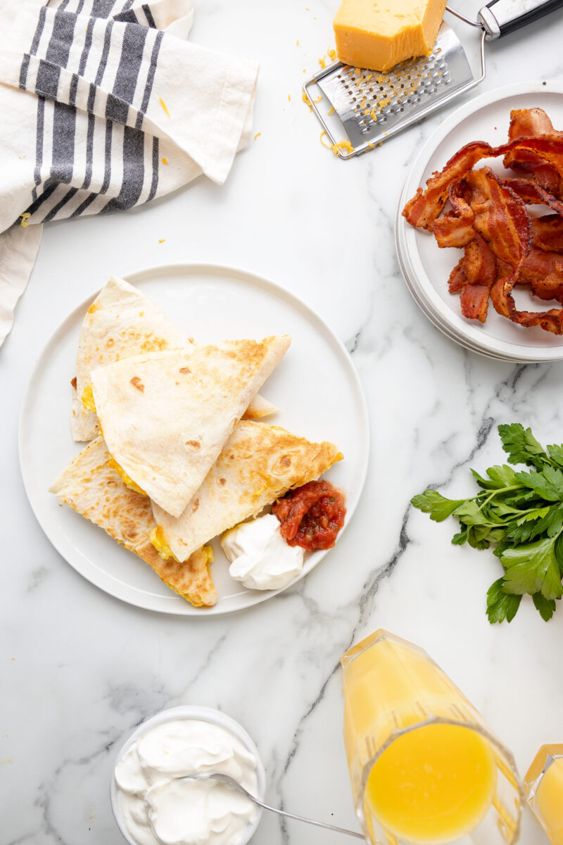 overhead view of breakfast quesadillas on a white plate.