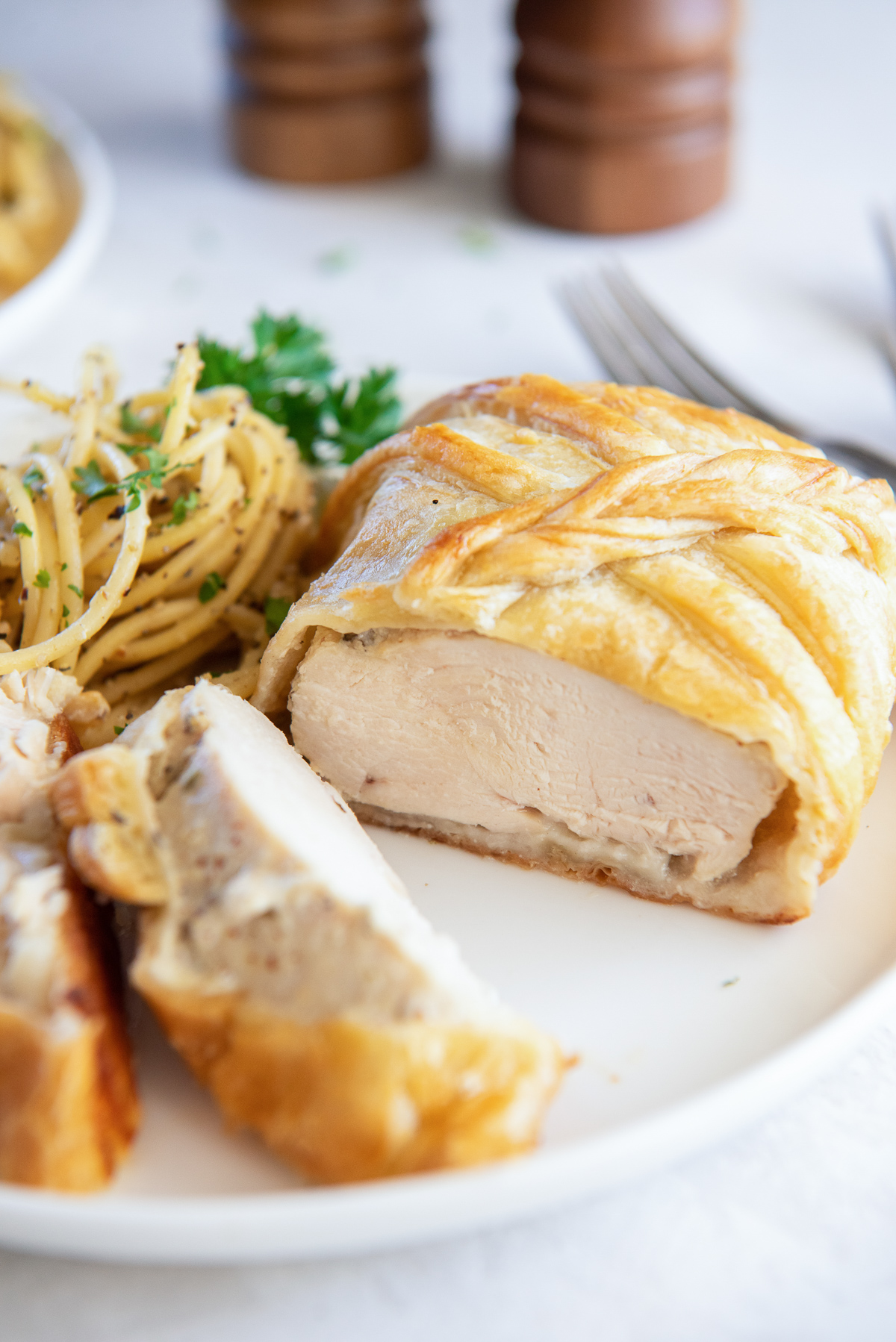 close up on chicken alouette, cut open to show the chicken inside of the puff pastry