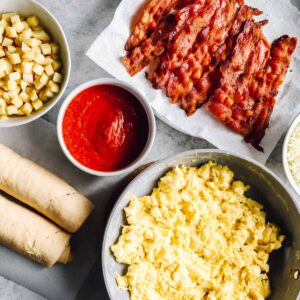 overhead view of ingredients for crescent roll breakfast pizza.