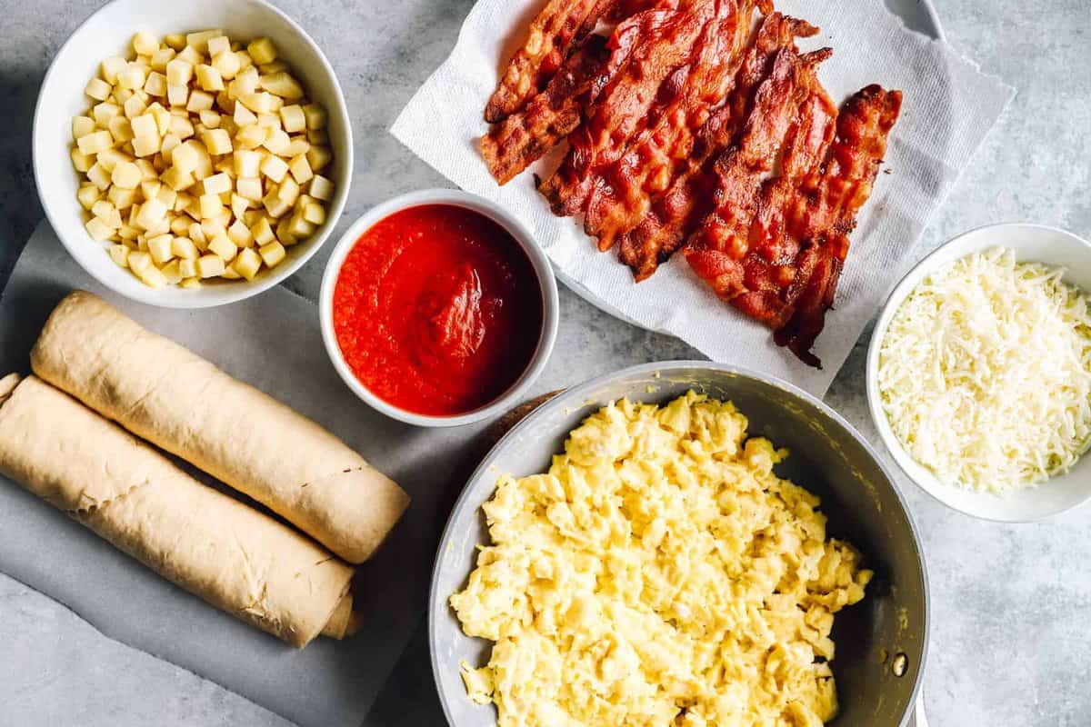 overhead view of ingredients for crescent roll breakfast pizza.