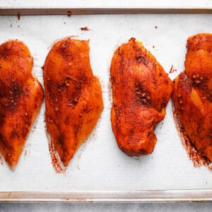 seasoned chicken breasts on a tray