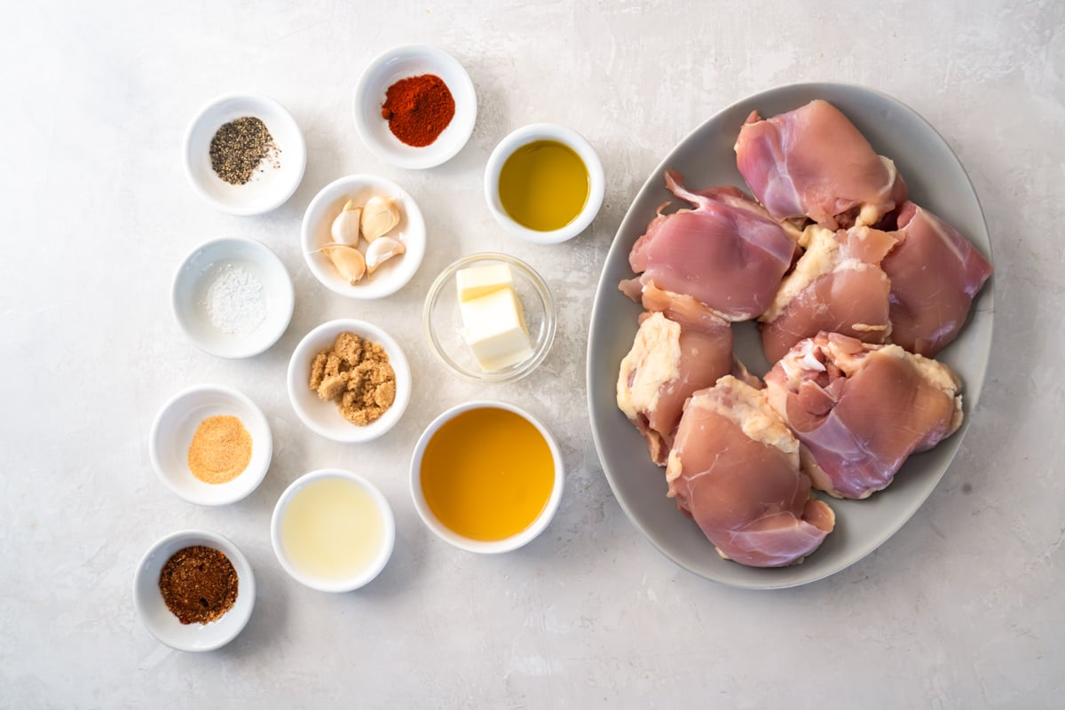 Ingredients for Cajun butter chicken arranged in dishes.