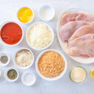 overhead view of ingredients for keto chicken parmesan in individual bowls.