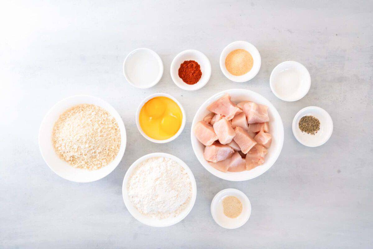 overhead view of ingredients for popcorn chicken in individual bowls.