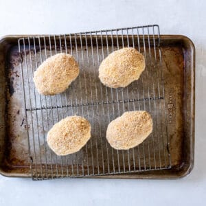 scotch eggs on a baking tray with a rack