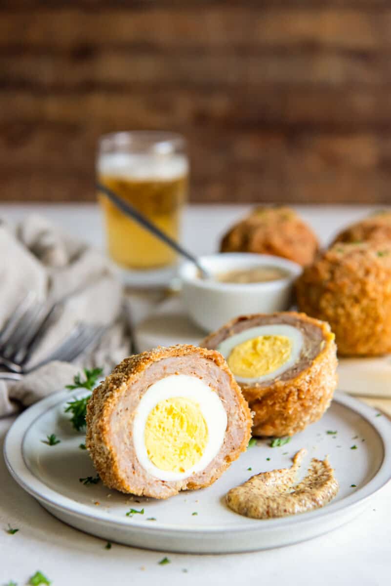 easy scotch egg on a plate with dijon mustard