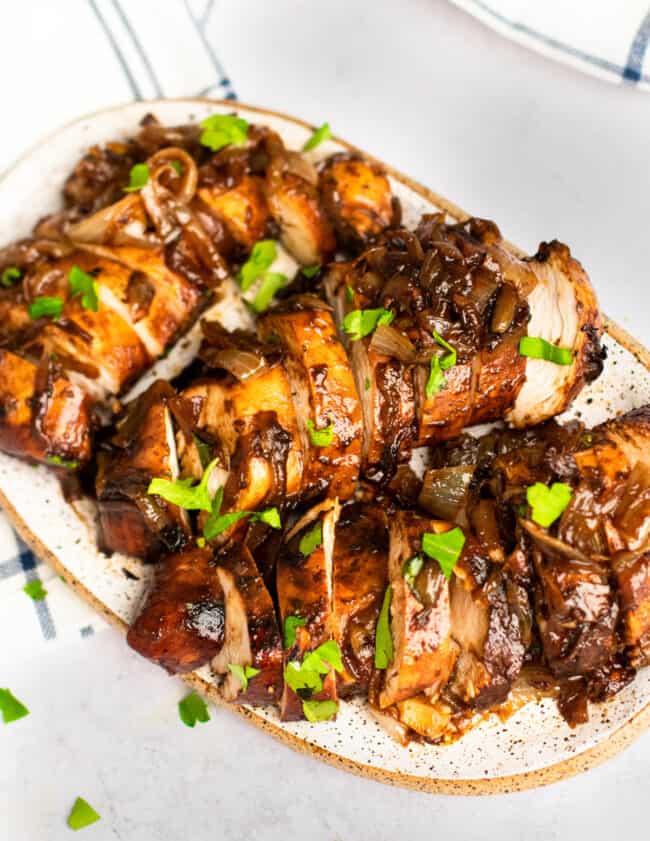 three-quarters view of sliced balsamic glazed chicken on a serving tray.