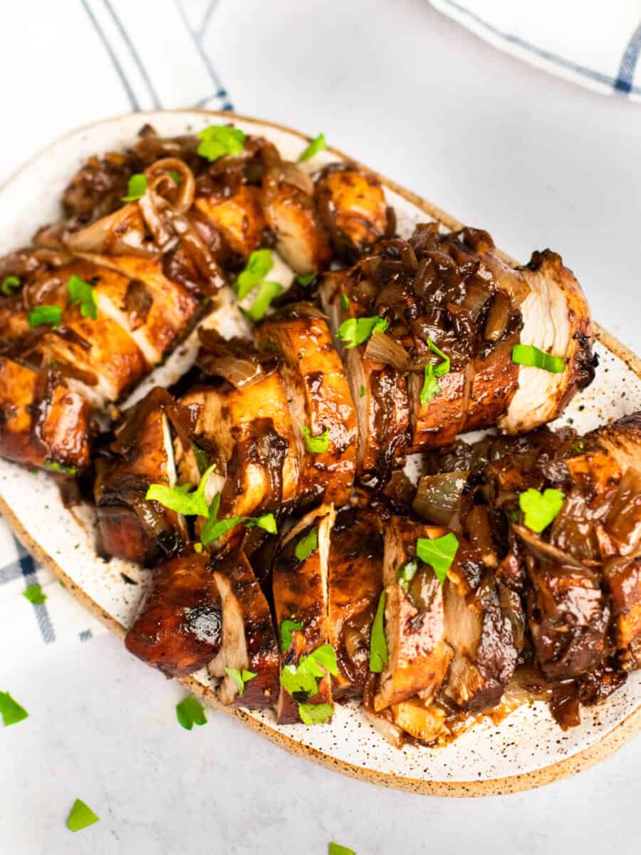 three-quarters view of sliced balsamic glazed chicken on a serving tray.