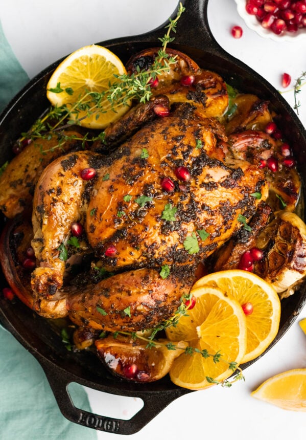 overhead view of christmas chicken in a cast iron skillet.