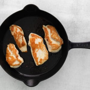 browning chicken breasts in a skillet