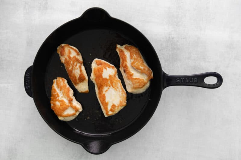 browning chicken breasts in a skillet