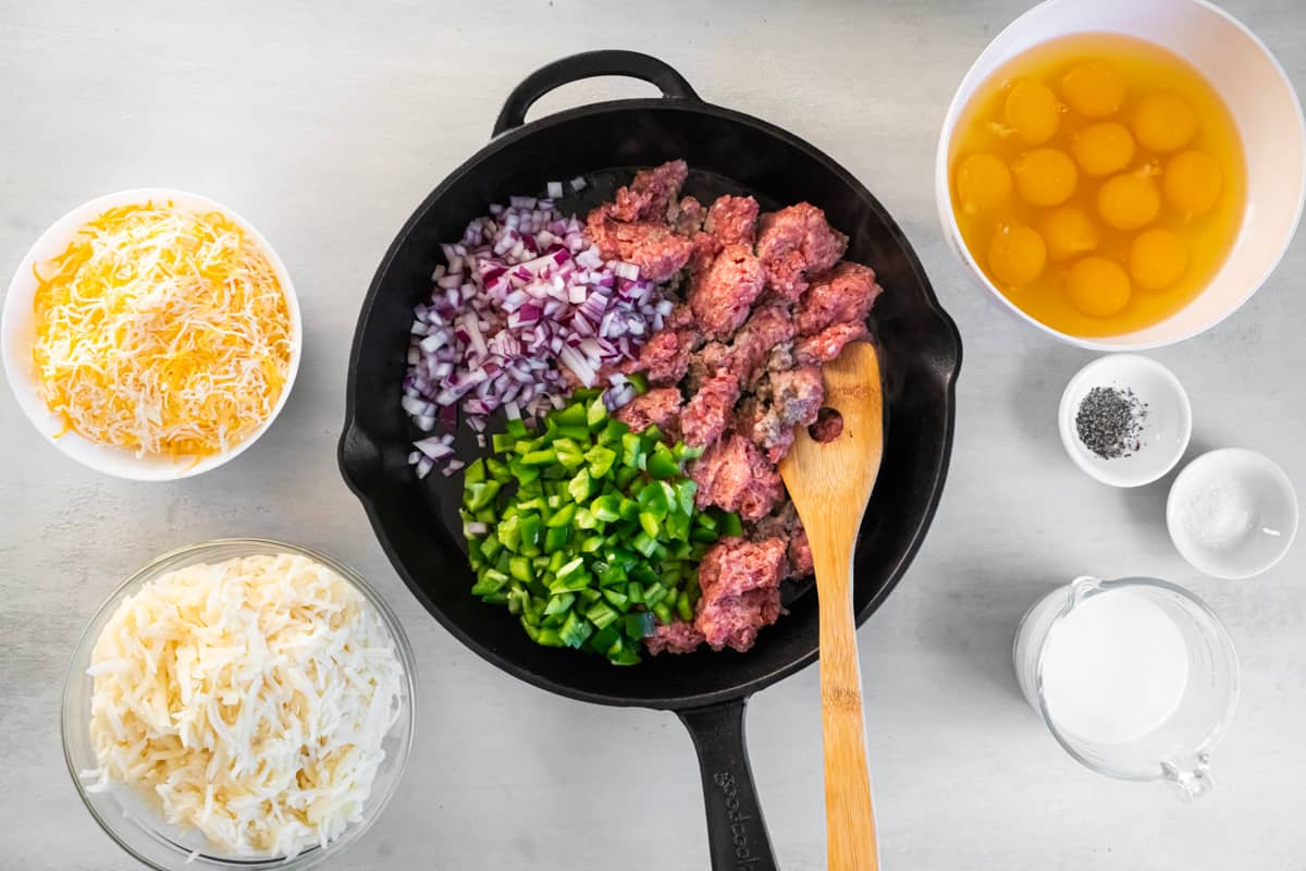 cooking breakfast sausage and veggies in a skillet