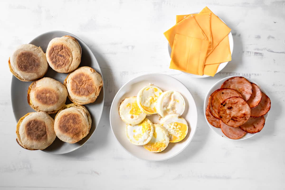 overhead view of cooked round eggs on a white plate.