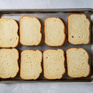 8 slices of toast on a baking sheet.