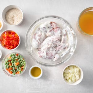 the ingredients for a chicken dish are shown on a white background.