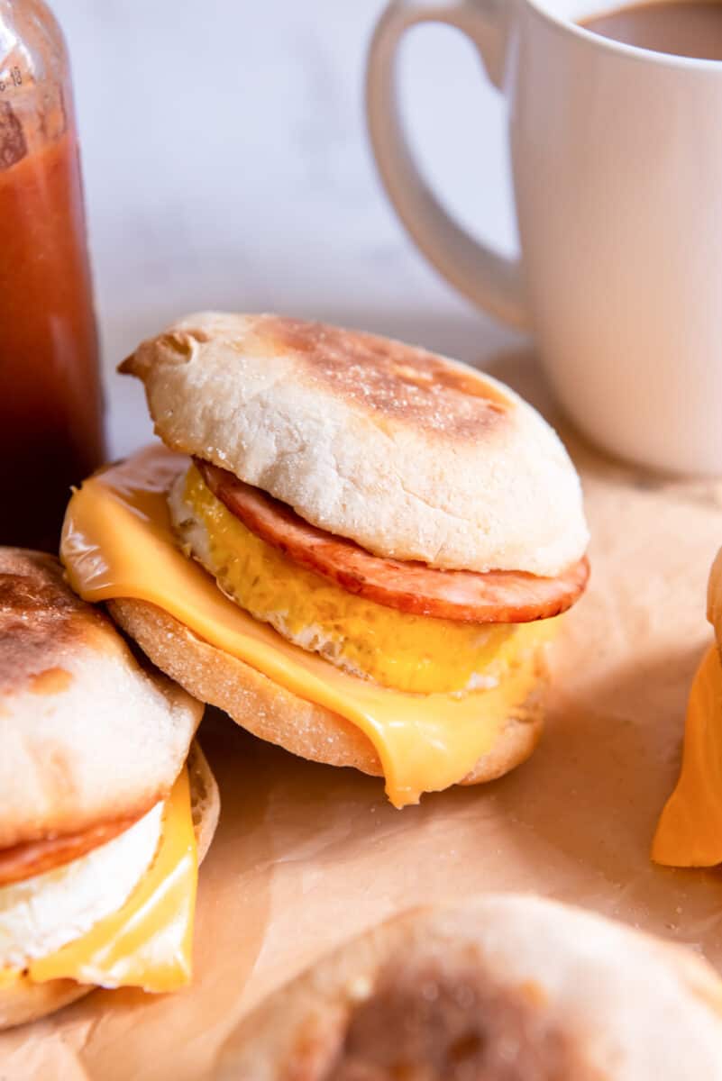 side view of an egg mcmuffin leaning against another egg mcmuffin.