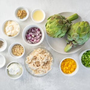 overhead view of ingredients for chicken salad stuffed artichokes.