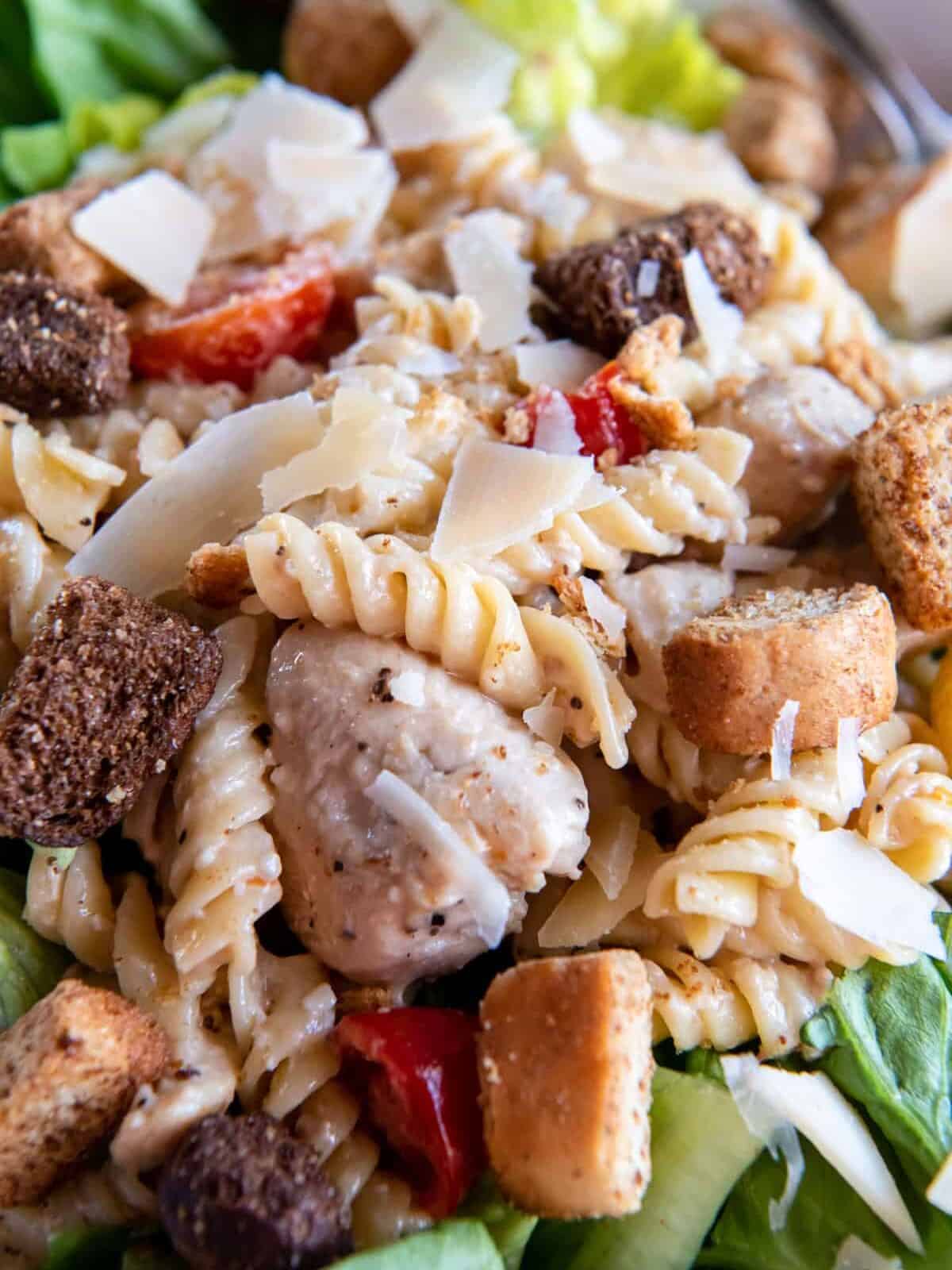close up view of chicken caesar pasta salad.