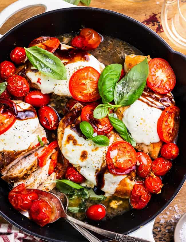 overhead view of chicken caprese in a skillet.