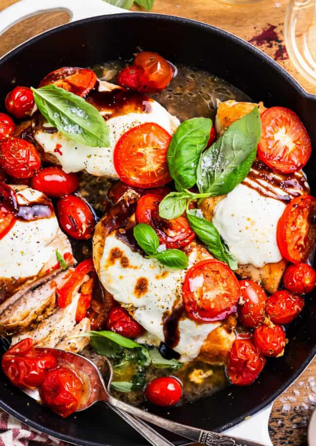 overhead view of chicken caprese in a skillet.