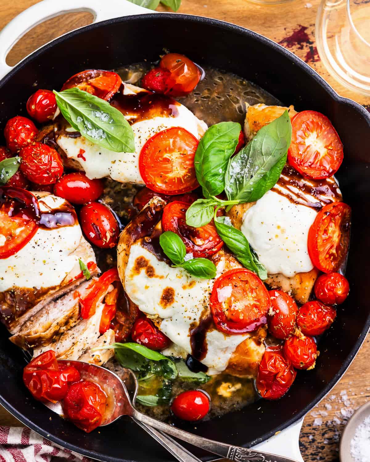 overhead view of chicken caprese in a skillet.