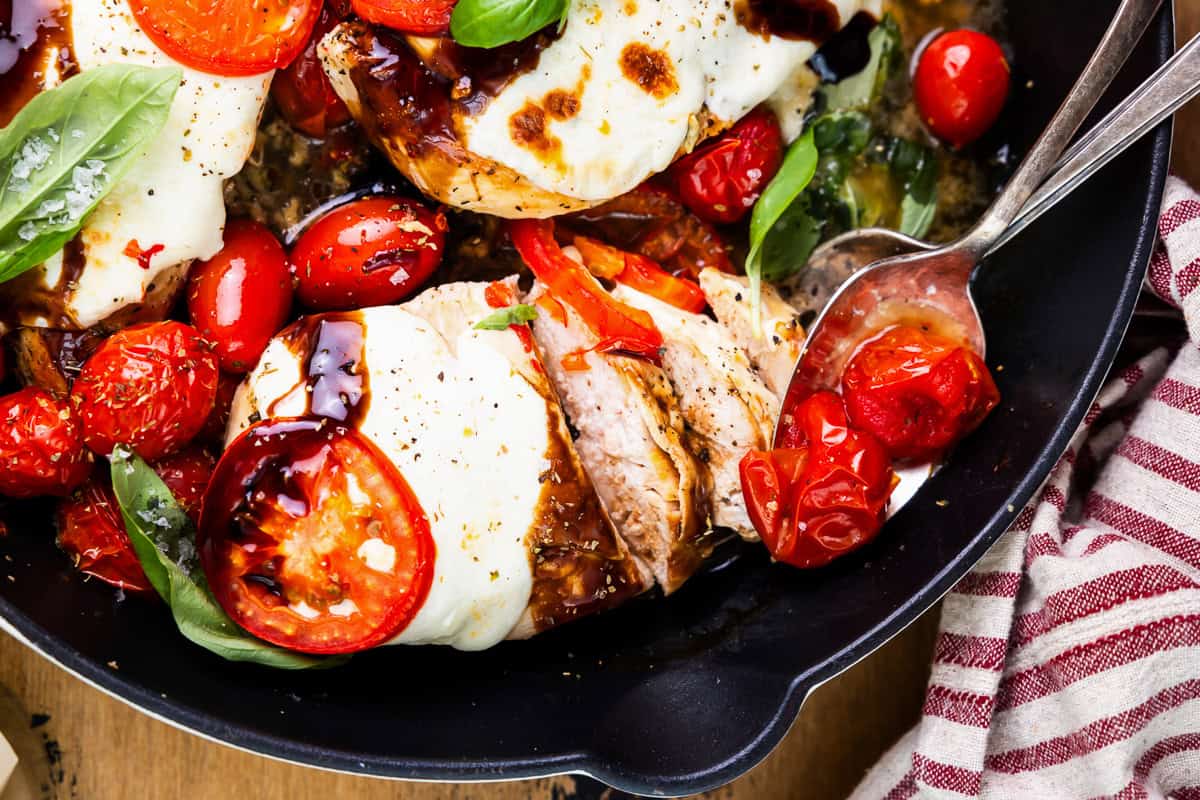 close-up view of chicken caprese in a skillet.