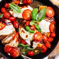 overhead view of chicken caprese in a skillet.