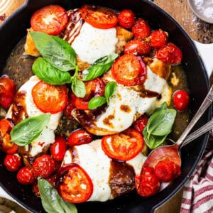 overhead view of chicken caprese in a skillet.