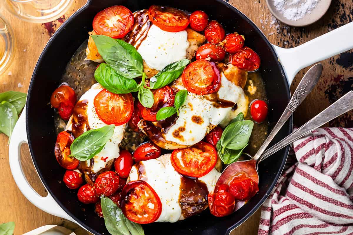 overhead view of chicken caprese in a skillet.