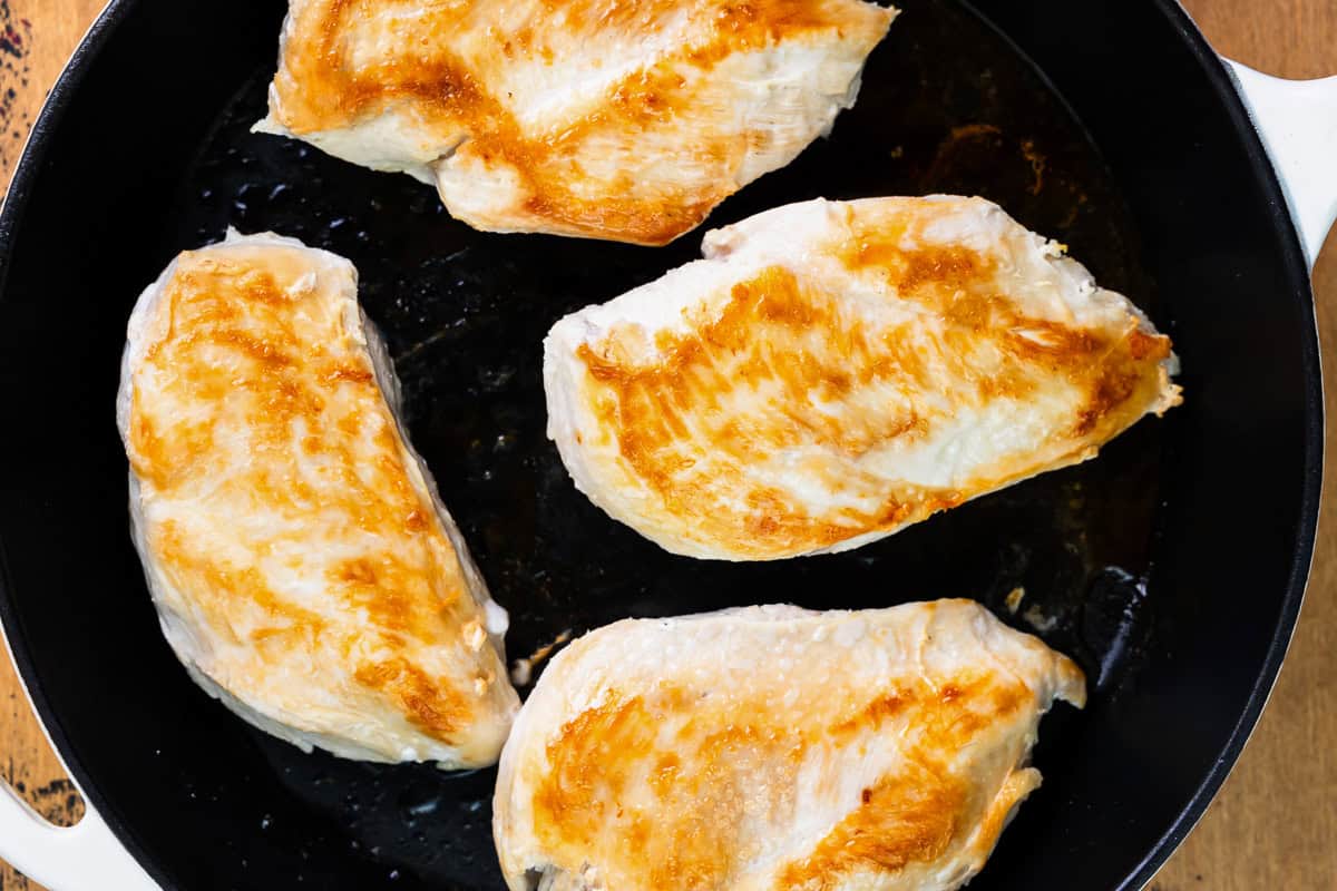 seared chicken breasts in a skillet.