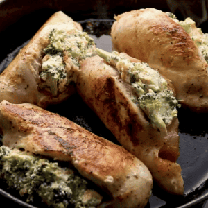 Broccoli and cheese stuffed chicken breast cooked in a skillet.