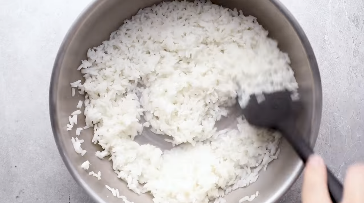 White rice is being cooked in a pot. 