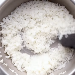 White rice is being cooked in a pot.