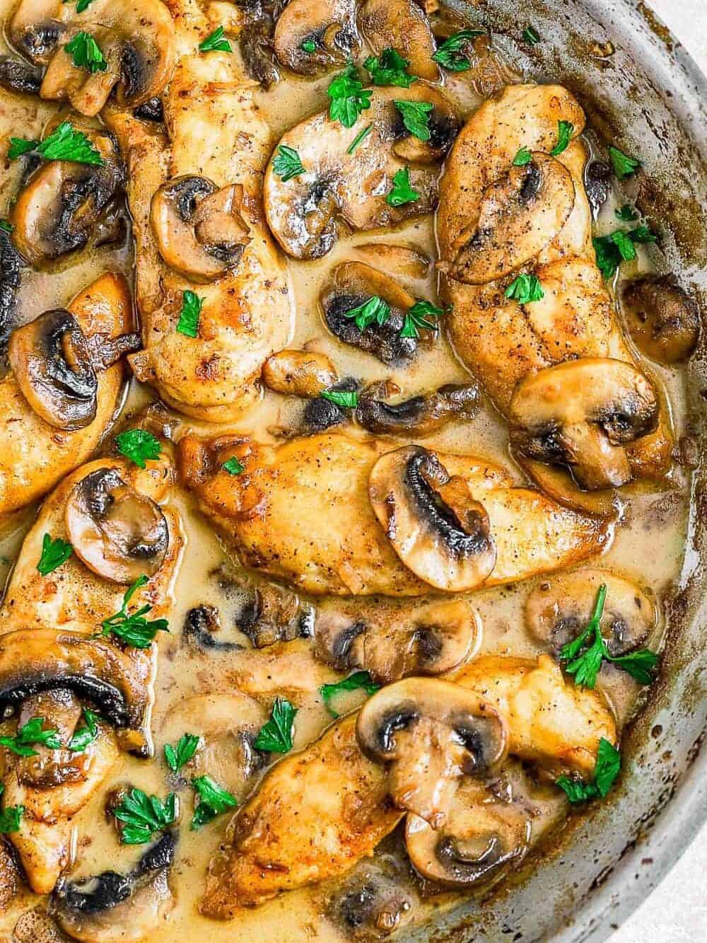 Chicken Marsala in a pan and garnished with fresh herbs