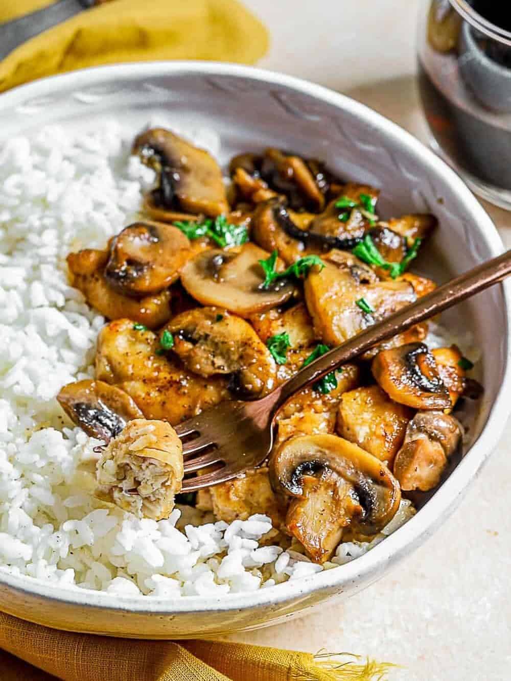 Chicken Marsala served in a bowl with a fork
