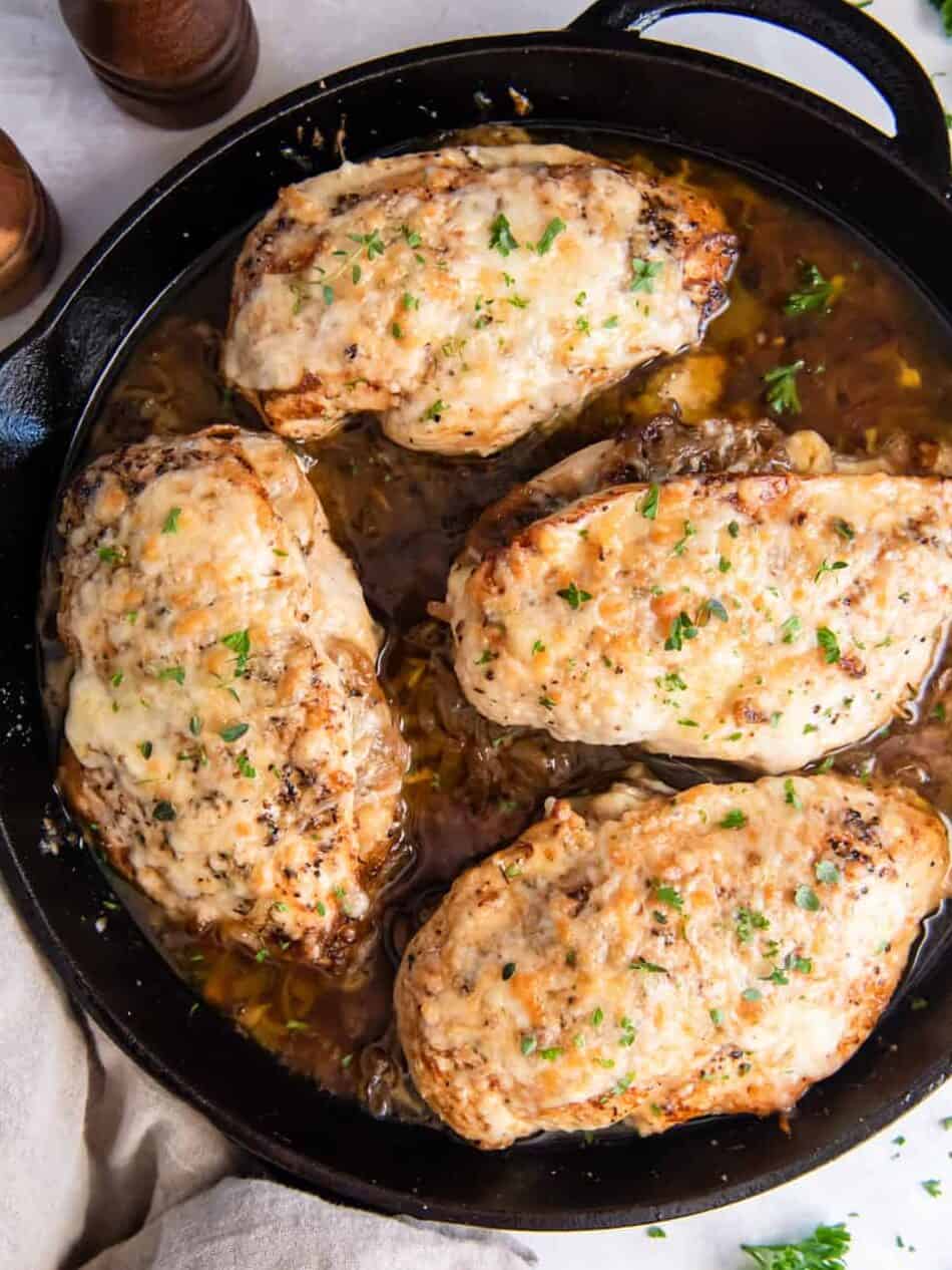 overhead view of french onion chicken in a cast iron skillet.